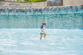 Boy playing in the paddling pool in the summertime Royalty Free Stock Photo