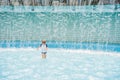 Boy playing in the paddling pool in the summertime Royalty Free Stock Photo