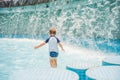 Boy playing in the paddling pool in the summertime Royalty Free Stock Photo