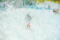 Boy playing in the paddling pool in the summertime Royalty Free Stock Photo