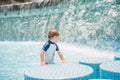 Boy playing in the paddling pool in the summertime Royalty Free Stock Photo