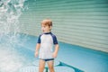 Boy playing in the paddling pool in the summertime Royalty Free Stock Photo