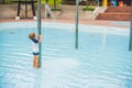 Boy playing in the paddling pool in the summertime Royalty Free Stock Photo