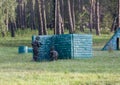 A boy is playing paintball on the field. two teams of paintball players in camouflage form with masks, helmets, guns on the field Royalty Free Stock Photo