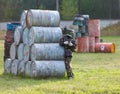 A boy is playing paintball on the field. two teams of paintball players in camouflage form with masks, helmets, guns on the field
