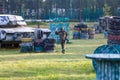 boy is playing paintball on the field. two teams of paintball players in camouflage form with masks, helmets, guns on the field Royalty Free Stock Photo