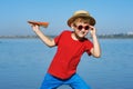 A boy playing with paper airplane on the lake Royalty Free Stock Photo