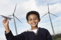Boy Playing With Paper Plane At Wind Farm Royalty Free Stock Photo