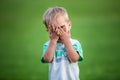 Boy playing peek-a-boo outdoors Royalty Free Stock Photo