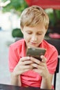 Boy playing phone Royalty Free Stock Photo