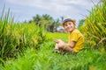 Boy playing phone sitting on the green grass, modern children, new technologies, children`s dependence on the phone Royalty Free Stock Photo