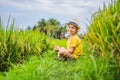 Boy playing phone sitting on the green grass, modern children, new technologies, children`s dependence on the phone Royalty Free Stock Photo