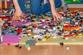 Boy playing with plastic construction toys on the floor.