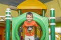 Boy playing on the playground, in the children`s maze. Cute boy having fun on playground