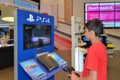 Boy Playing Playstation 4 in Sony Center, Dubai Mall, Dubai Royalty Free Stock Photo