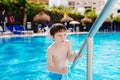Boy playing on pool. Royalty Free Stock Photo