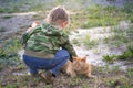 The boy is playing with a red cat. Royalty Free Stock Photo