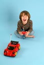 Boy playing with a remote controlled toy car Royalty Free Stock Photo