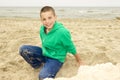Boy playing in sand on beach, Northern Sea coast