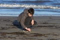 Boy playing with sand on the beach