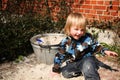 Boy playing beside sand box Royalty Free Stock Photo
