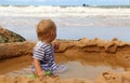 Boy playing in sand pool