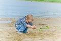 Boy playing in the sand on shore of Lake Royalty Free Stock Photo