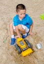 Boy playing in the sand with toys Royalty Free Stock Photo