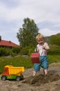 Boy playing in sandpit