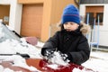 Boy playing with snow outside Royalty Free Stock Photo