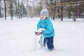 Boy playing in the snow outside in winter Royalty Free Stock Photo
