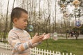 Boy playing soapbubbles