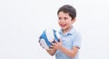 Boy playing with soccer ball, isolated on white studio background. Portrait of kid football player with ball in hand. Young cute Royalty Free Stock Photo