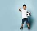 Boy playing soccer, happy child, young male teenager goalkeeper enjoying sports game, holding ball Royalty Free Stock Photo