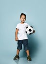 Boy playing football, happy child, young male teen goalkeeper enjoying sport game, holding ball,  preteen smiling and having fun Royalty Free Stock Photo