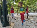 A boy is playing soccer under a tree in their yard while doing the famous soccer player style after scoring a goal.