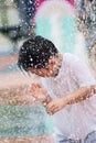 Boy playing with spraying water