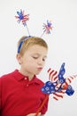 Boy Playing With Stars And Stripes Pinwheel Royalty Free Stock Photo
