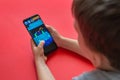 Boy playing Super Mario Run mobile game on Samsung Galaxy S9 plus phone close-up