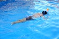 A boy is playing in a swimming pool with Easybreath mask