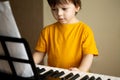 A boy playing the synthesizer