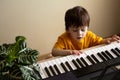 A boy playing the synthesizer
