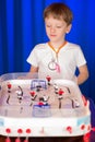 Boy playing table hockey Royalty Free Stock Photo