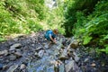 Boy playing into te forest stream at summer day Royalty Free Stock Photo