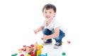 Boy playing toy on the floor over white background Royalty Free Stock Photo