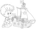 Boy playing a toy ship