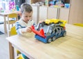 Boy playing with toys in kindergarden