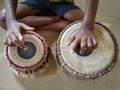 Boy playing traditional Indian musical instrument Tabla