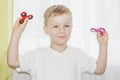 Boy playing with two Hand Spinner.