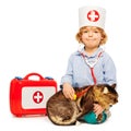 Boy playing veterinarian with stethoscope and cat Royalty Free Stock Photo